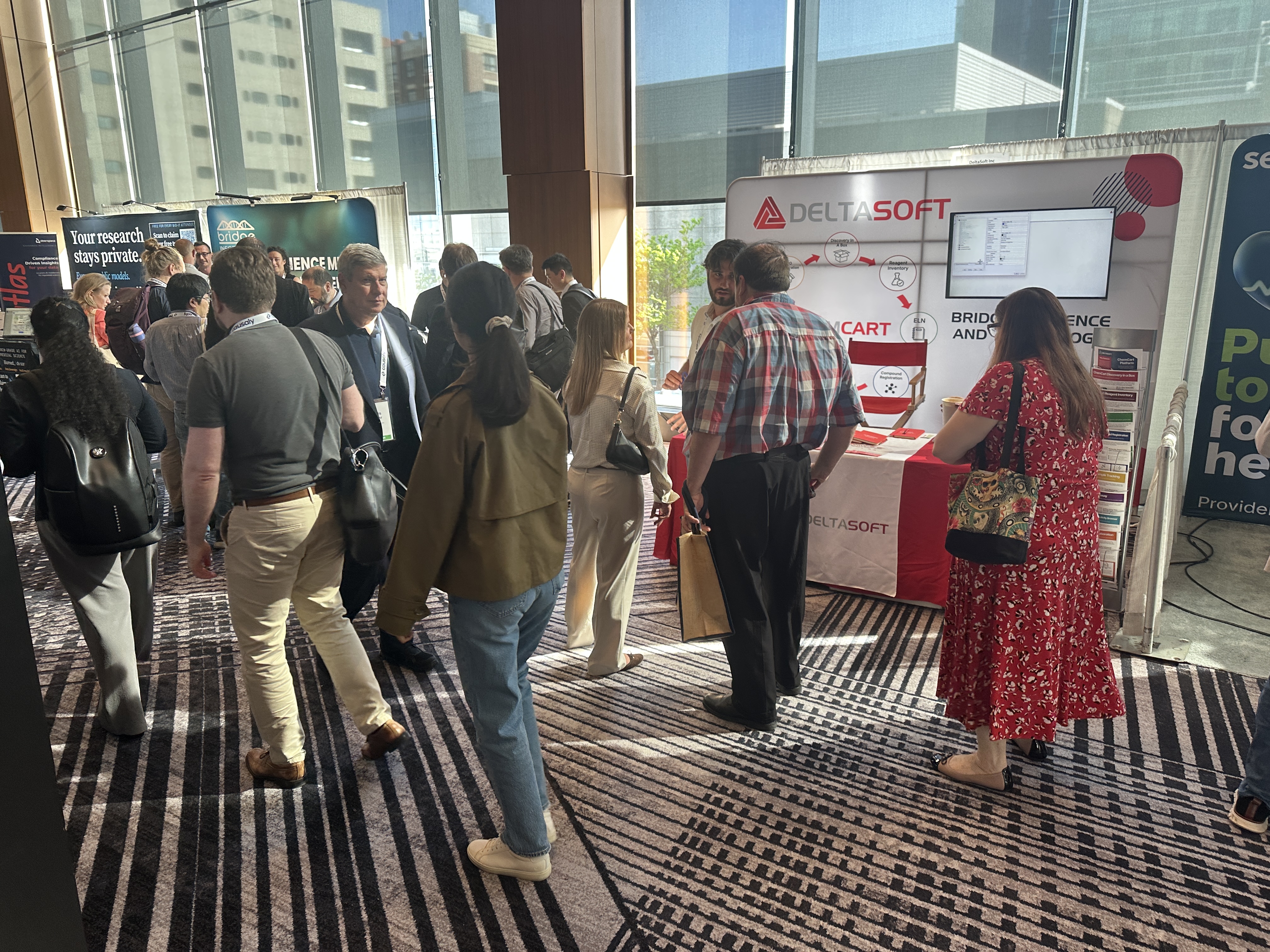 Attendees visiting the DeltaSoft booth at Bio-IT World 2026